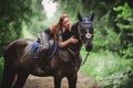 Portrait of attractive woman and black hanoverian stallion horse Royalty Free Stock Photo