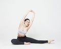 Portrait of attractive woman doing yoga, pilates over light grey background. Healthy lifestyle and sports concept. Royalty Free Stock Photo