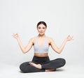 Portrait of attractive woman doing yoga, pilates over light grey background. Healthy lifestyle and sports concept. Royalty Free Stock Photo