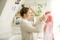 Portrait of attractive woman dressing a tailor dummy mannequin