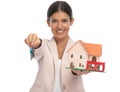 Portrait of attractive woman giving keys and showing building model Royalty Free Stock Photo