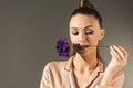 portrait of attractive woman holding flower in teeth Royalty Free Stock Photo