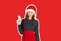 Portrait of attractive woman pointing up with index finger. emotional girl in santa claus christmas hat Magazine collage style