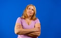 Portrait of an attractive woman posing with arms crossed looking away with thoughtful expression Royalty Free Stock Photo