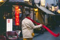 Portrait of an attractive woman with a scarf. A walk through the city in a Japanese neighborhood.