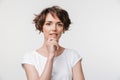 Portrait of attractive woman with short brown hair in basic t-shirt looking at camera Royalty Free Stock Photo