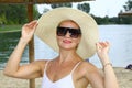 Portrait of an attractive woman with sunglasses and a hat on the beach Royalty Free Stock Photo