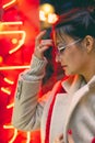 Portrait of an attractive woman wearing blue glasses in a Japanese neighborhood. Royalty Free Stock Photo