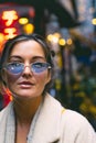 Portrait of an attractive woman wearing blue glasses in a Japanese neighborhood. Royalty Free Stock Photo