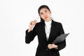 Portrait of attractive young Asian business woman holding pen and having idea posing over white isolated background Royalty Free Stock Photo