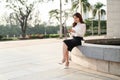 Portrait of attractive young Asian business woman sitting in cafe and using mobile smart phone in her hands Royalty Free Stock Photo