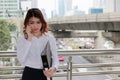 Portrait of attractive young Asian business woman talking on phone in urban building city with copy space background. Royalty Free Stock Photo