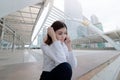 Portrait of attractive young Asian business woman talking on phone in urban building city with copy space background. Royalty Free Stock Photo