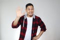 Portrait of attractive young Asian man shows hi or high five gesture with his fingers Royalty Free Stock Photo