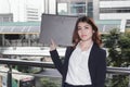 Portrait of attractive young Asian secretary woman holding document folder at outside office Royalty Free Stock Photo
