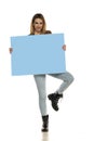 Portrait of attractive young beautiful woman holding blank blue billboard Royalty Free Stock Photo