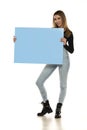 Portrait of attractive young beautiful woman holding blank blue billboard Royalty Free Stock Photo