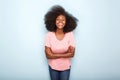 Attractive young black woman smiling with arms crossed against isolated blue background Royalty Free Stock Photo