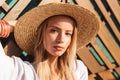 Portrait of attractive young blond woman 20s in straw hat and sw Royalty Free Stock Photo