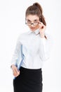 Portrait of attractive young businesswoman with folder looking over glasses Royalty Free Stock Photo