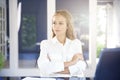 Beautiful young businesswoman portrait while sitting in the office Royalty Free Stock Photo