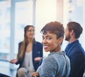 Come join the winning team. Portrait of an attractive young businesswoman smiling and posing during a meeting with her Royalty Free Stock Photo