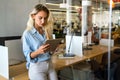 Portrait of an attractive young businesswoman smiling working on digital tablet in office Royalty Free Stock Photo