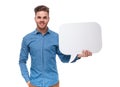 Portrait of attractive young casual man holding speech bubble Royalty Free Stock Photo