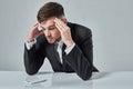 Portrait of attractive young caucasian man using cellular phone while sitting at office table. Royalty Free Stock Photo