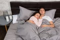 Portrait of attractive young couple hugging each other while sleeping in the bed Royalty Free Stock Photo