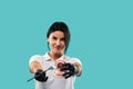 Portrait of an attractive young woman dentist holding a model of human teeth and examining it using a dental mirror isolated on a Royalty Free Stock Photo