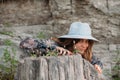 Portrait of an attractive young girl with long blond hair, a small hat and a blue summer shirt Royalty Free Stock Photo