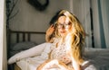 Portrait of attractive young happy caucasian woman in glasses, sitting in cozy bedroom Royalty Free Stock Photo