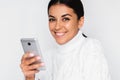 Portrait of attractive young happy woman with mobile phone with pretty toothy smile, on the white background. Royalty Free Stock Photo