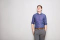 Attractive young man standing against gray background Royalty Free Stock Photo