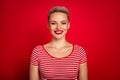 Portrait of attractive young pretty woman short haircut wearing striped stylish t shirt toothy smiling isolated on red Royalty Free Stock Photo