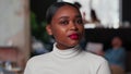 Portrait of attractive young 20s gen-z African business woman with red lips looking at camera at light trendy office. Royalty Free Stock Photo