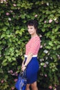 Portrait of an attractive young sensual woman on a background of ivy wall with green leaves. Royalty Free Stock Photo