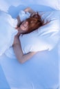 portrait of attractive, young, sexy laughing redhead, red hair in her face woman, enjoys the fresh soft bed, relaxed in the Royalty Free Stock Photo