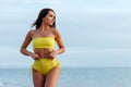 Portrait of attractive young woman in bikini on the beach. Royalty Free Stock Photo