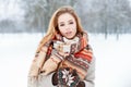 Portrait of an attractive young woman with brown eyes with a stylish woolen vintage beautiful scarf in mittens Royalty Free Stock Photo