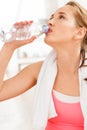 Portrait of attractive young woman drinking water at gym Royalty Free Stock Photo