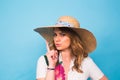 Portrait of attractive young woman with finger on lips gesturing silence, studio shot Royalty Free Stock Photo