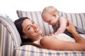 Hes my pride and joy. Portrait of an attractive young woman and her baby girl lying on the sofa. Royalty Free Stock Photo