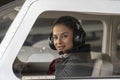 Young Woman Pilot With Headset Looking Through The Cockpit Window Royalty Free Stock Photo