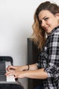 Portrait of beautiful young woman is playing the piano Royalty Free Stock Photo