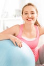 Portrait of attractive young woman relaxing fitness ball at gym Royalty Free Stock Photo