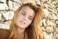 Portrait of attractive young woman and stone wall Royalty Free Stock Photo