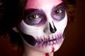 Attractive young woman with sugar skull halloween makeup