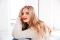 Portrait of attractive young woman wearing sweater and red lipstick Royalty Free Stock Photo